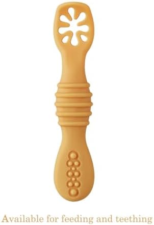 An infant holding the easy grip PandaEar silicone learning spoon during a meal.