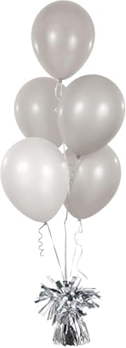 A cluster of helium party balloons anchored securely onto a white metallic table weight at a birthday celebration.