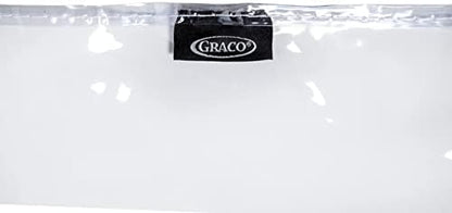 Parent wiping down the clear vinyl floor mat easily with a damp cloth after lunch