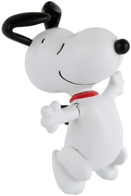 Three inch Peanuts Snoopy collectible pocket toy displayed on an office desk next to stationery