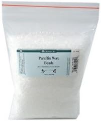 Close up of small white food grade paraffin wax pellets for baking and cosmetic use.