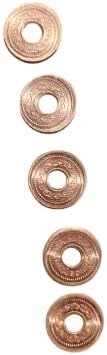 Five pieces of authentic tambe ke sikke displayed clearly to showcase the premium metal texture and central hole.
