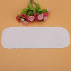 Modern baby cloth diaper insert being placed into nappy shell