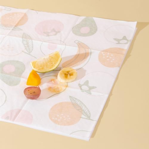 Close up view of the three layer waterproof stick on table mat showing the fruit design on a restaurant table