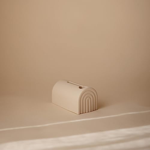 Soft silicone Mushie bath faucet guard installed on tub