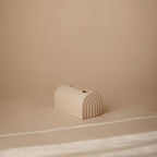 Soft silicone Mushie bath faucet guard installed on tub