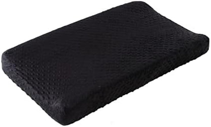 Gender-neutral black Queness Baby changing table cover displayed in a modern nursery room setting.