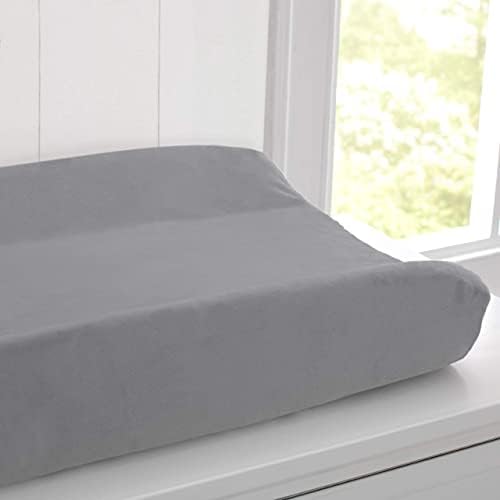 Contoured baby changing pad with plush fabric cover removed showing the inner foam structure.