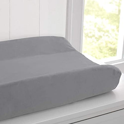 Contoured baby changing pad with plush fabric cover removed showing the inner foam structure.