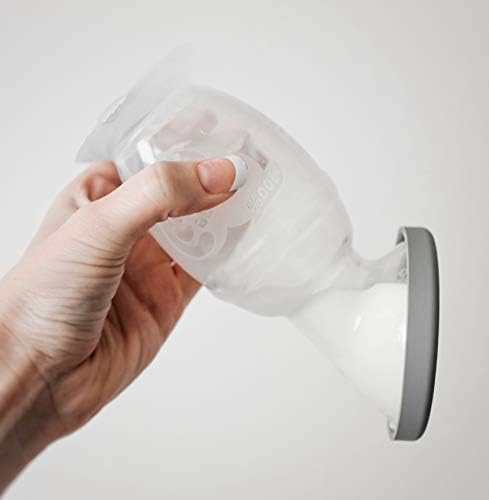 Grey leak-proof silicone cap fitted onto the Haakaa breast pump.