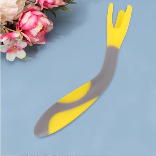 Side view of flexible yellow baby training fork bent at an angle