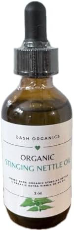 Two ounce glass bottle of organic stinging nettle scalp nourishing treatment showcasing its rich botanical color.