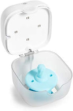 Compact Munchkin UV sterilizer next to a diaper bag for size reference