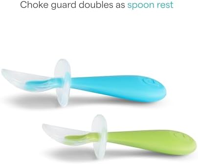 Toddler training utensils resting on a table demonstrating the integrated spoon rest functionality