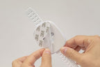 Complete contents of the YEYA anti-tip kit including two adhesive plates, adjustable straps, and instruction manual.