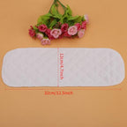 Stack of ten white washable nappy inserts for babies