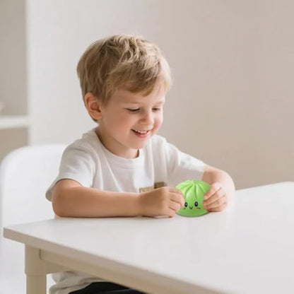PLGEBR dumpling fidget sensory toy displayed on a modern office desk setup next to a laptop to show its size as a stress relief desk toy