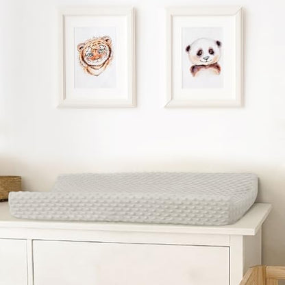 Newborn baby lying on plush minky dot changing pad cover