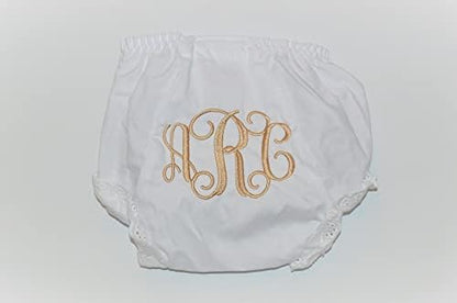Close up of monogrammed baby diaper cover with lace trim details