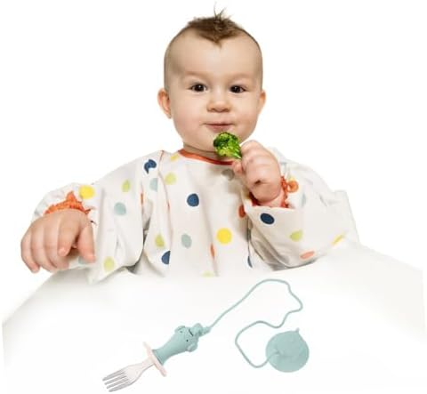 Toddler using Totority stainless steel feeding utensils on highchair