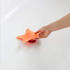 Boon starfish shaped soft silicone bath stopper in orange