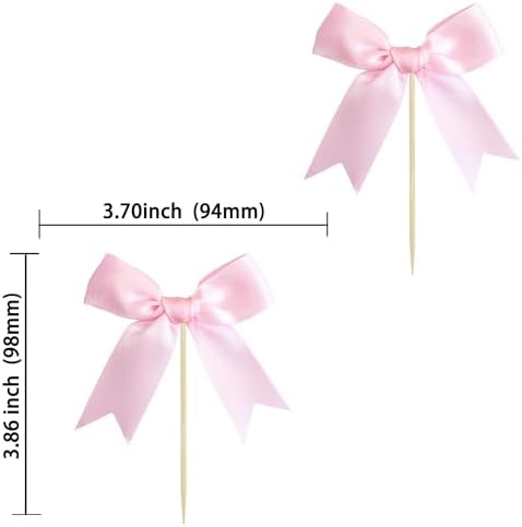 Close up of satin pink bow cake topper on a cupcake
