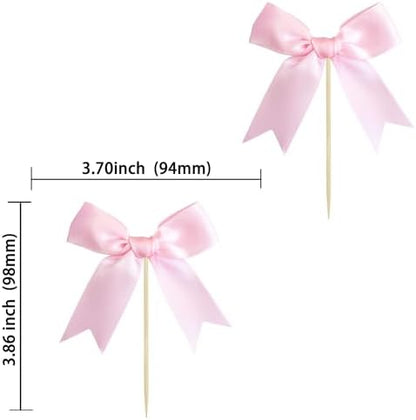 Close up of satin pink bow cake topper on a cupcake
