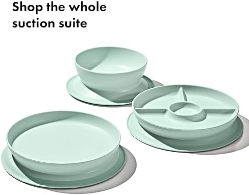 Parent hands removing the OXO Tot suction plate from a table