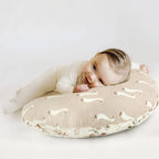 Baby resting on a Grssder duck pattern nursing pillow
