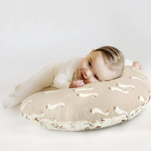 Baby resting on a Grssder duck pattern nursing pillow