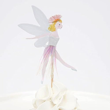 Decorative fairy toppers inserted in festive dessert