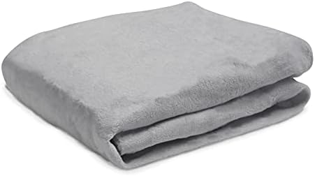Delta Children grey plush baby changing station set up on a standard wooden dresser topper.