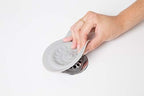 Ubbi drain stopper demonstrating the flexible silicone material