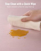 Wiping clean the waterproof surface of the Blissful Diary baby floor mat after a spill.