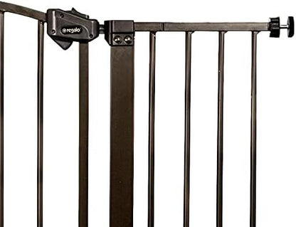 Regalo extra tall metal safety barrier installed at bottom of stairs