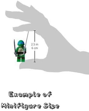 Moulded white plastic building block toy character standing on a flat surface.