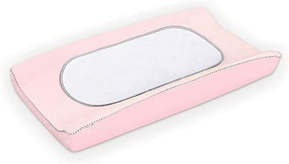 Three white Munchkin changing pad liners stacked together