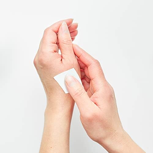 Person using a medicated sting relief pad on a mosquito bite for itch relief.
