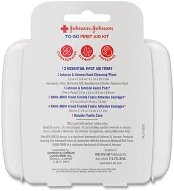 Handheld view of the Johnson & Johnson Red Cross travel kit illustrating small portable size.