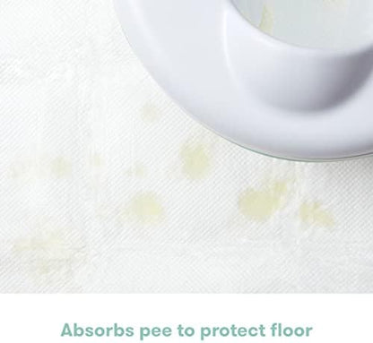 Frida Baby absorbent floor pad demonstrating liquid containment to prevent floor messes