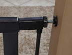 MidWest dog gate installation setup highlighting the adjustable tension knobs and wall pads.
