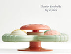 Itzy Ritzy baby bath spinner toy attached securely to a bathtub surface demonstrating water resistant construction.