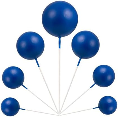 Close up view of various sizes of blue balloon cake picks