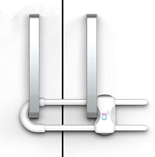 White child safety lock installed on kitchen cabinet handles
