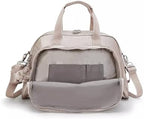 Stroller clips attached to the Kipling camama shoulder bag