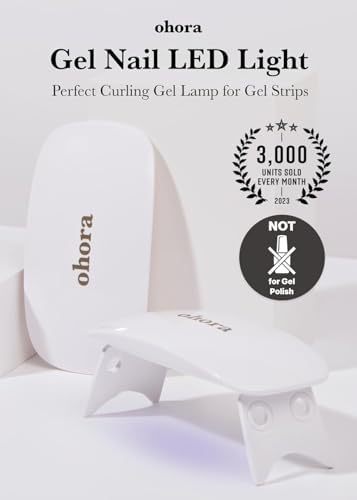 Portable Ohora UV LED nail light emitting blue light while curing semi cured gel strips.