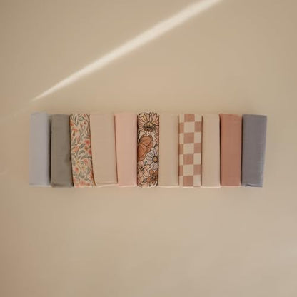 Three pack Mushie changing pad liners folded for storage