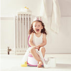 Toddler using Spark Moments travel potty outdoor