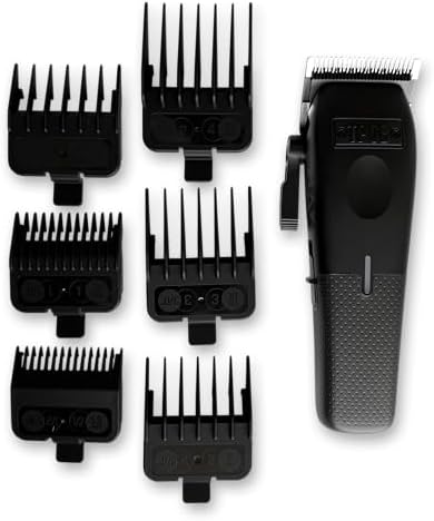 TPOB Mini Play professional barber clipper being held to demonstrate the ergonomic compact design and grip.