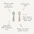Two pack of Mushie silicone baby spoons for self feeding showing ergonomic short handles